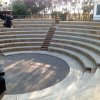 Gradinate di un anfiteatro vuote, con vista degli spalti curvi.