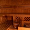 Sauna in legno con secchio e pietre.