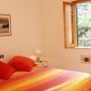 Camera da letto con letto colorato e finestra aperta.