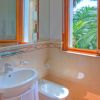 Bagno con lavabo, bidet e finestra aperta.